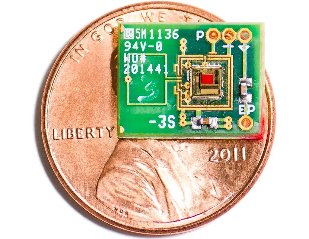 An experimental ear-powered chip, with a penny for scale