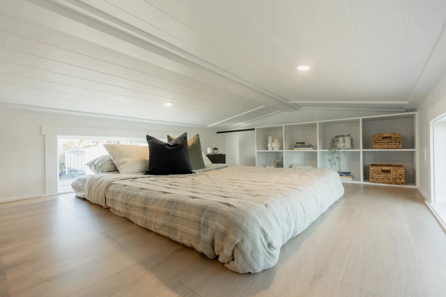 The Ventura Park Model Tiny Home includes two loft-style tiny house bedrooms with low ceilings