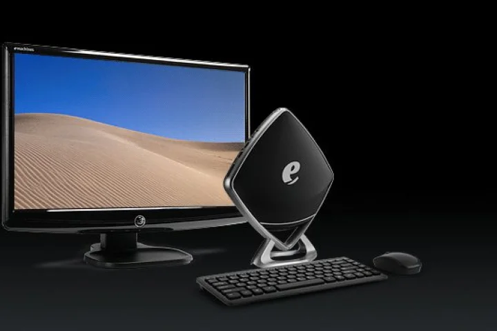 The glossy black diamond shape of the Mini-e from eMachines could well see it take front stage on a user's desk instead of being hidden behind monitors like others of its kind