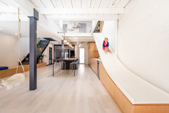 Atelier Chabot is arranged around an open and light-filled living area that contains a slide
