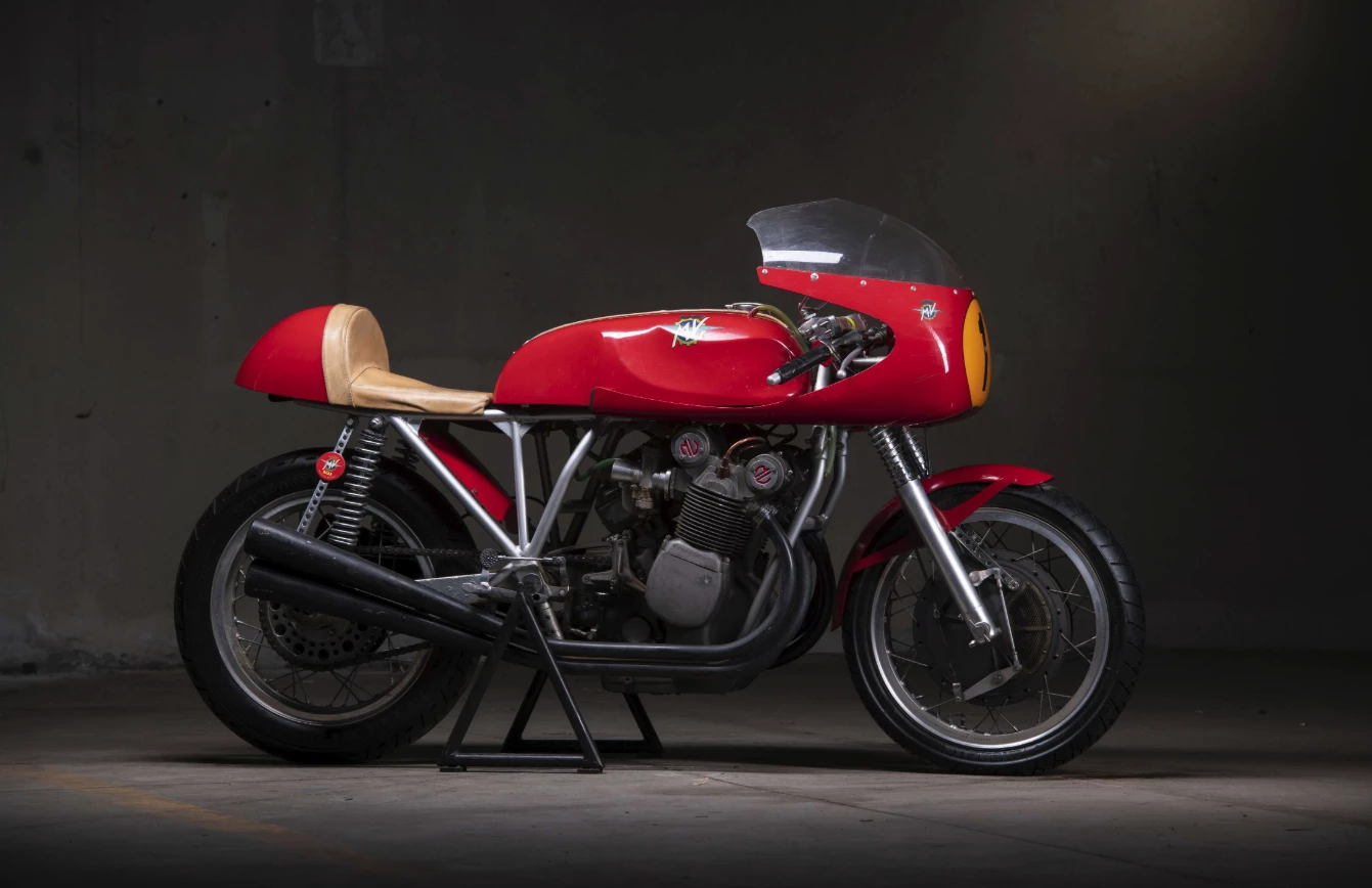 1972 MV Agusta 750 S John Surtees Tribute | Perhaps the most interesting of the six MV Agusta 750 S bikes available at Retromobile this year is this John Surtees tribute bike which is based on a 750 S motor and frame, and is believed to have been one of five constructed by legendary MV Agusta race engineer Arturo Magni. It incorporates Magni's proprietary chain drive conversion, a 300 mm Fontana drum brake, 48 mm Marzocchi forks and four Dell'Orto SSI 29 carburetors. It is no longer a road bike, as all lights and registration requirements have been removed in the construction, but is still estimated to fetch close to the current record auction price for a 750 S at €75,000 to €120,000.