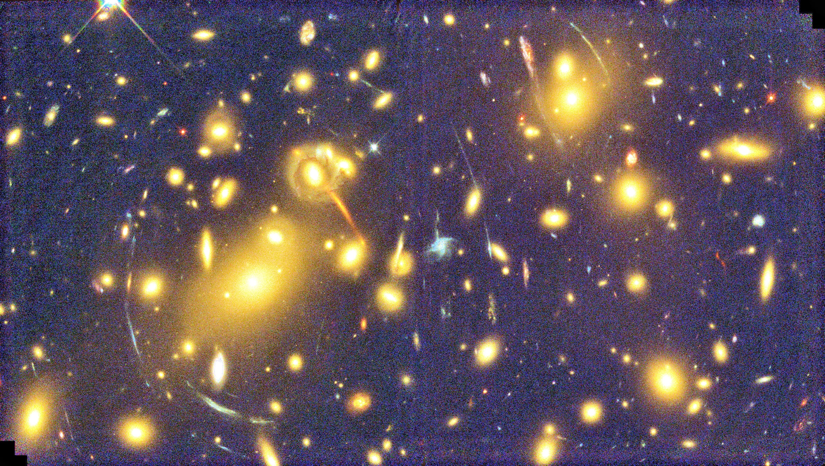 A view through massive galaxy cluster Abell 1689, showing the characteristic arcs of gravitational lensing