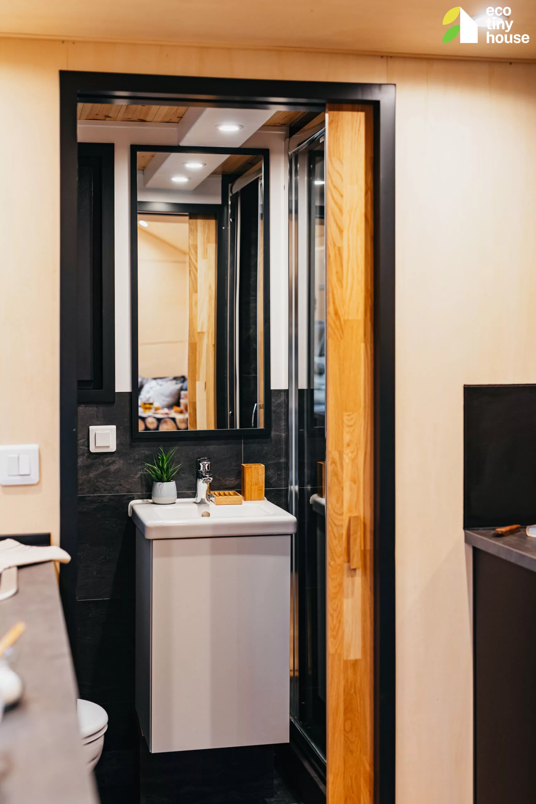 The Tiny Hogwarts' bathroom has a small floating vanity sink, a flushing toilet, and a shower