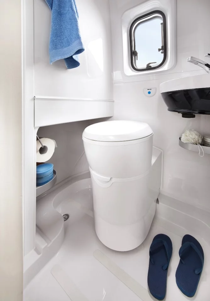 The compact bathroom relies on a swivel toilet to keep things comfortable