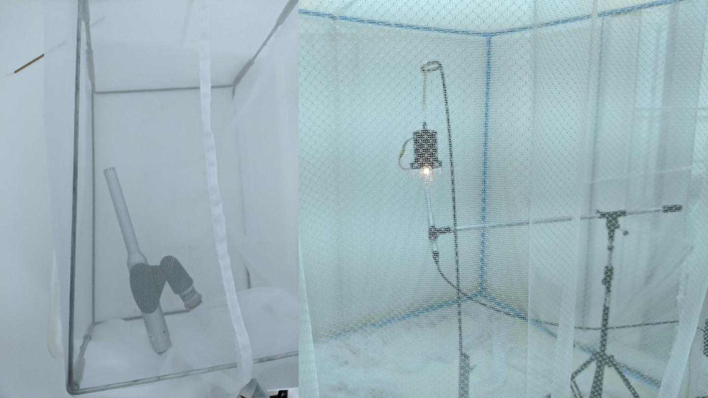 The prototype device, set up in a mosquito-netted lab