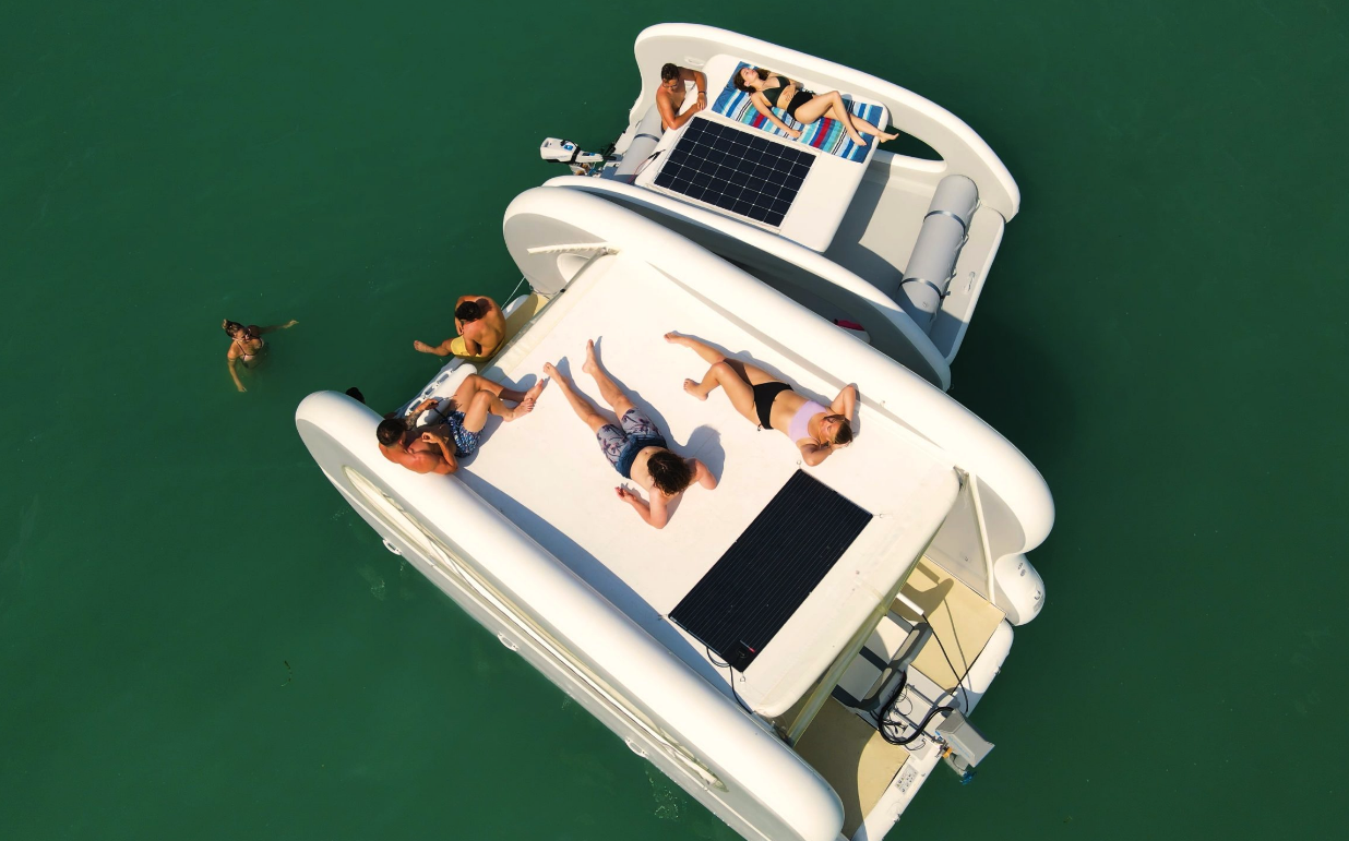 The larger Portless Catamaran Deluxe and standard model team into a party island