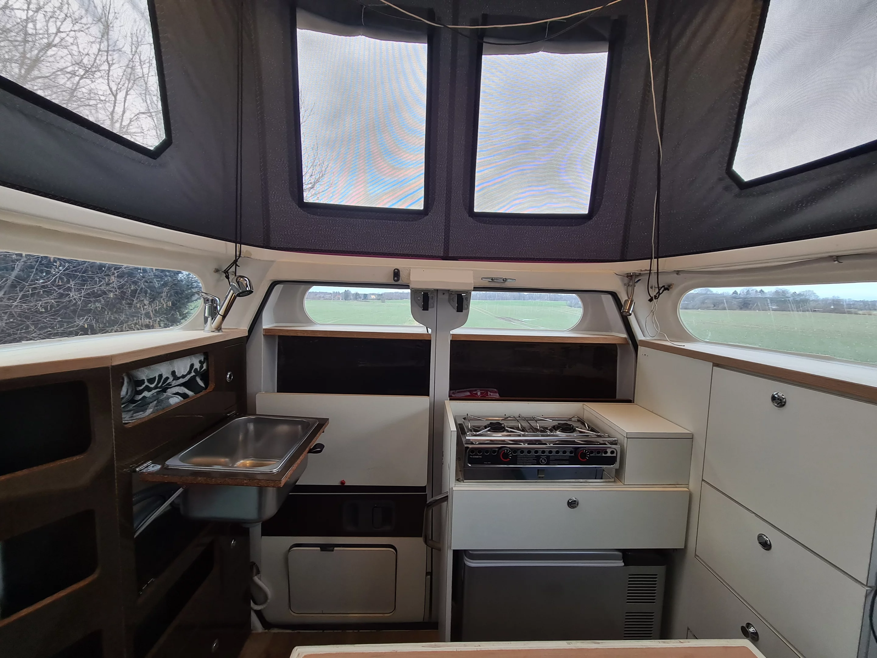 Cabineer kitchen with stove and sink ready to work