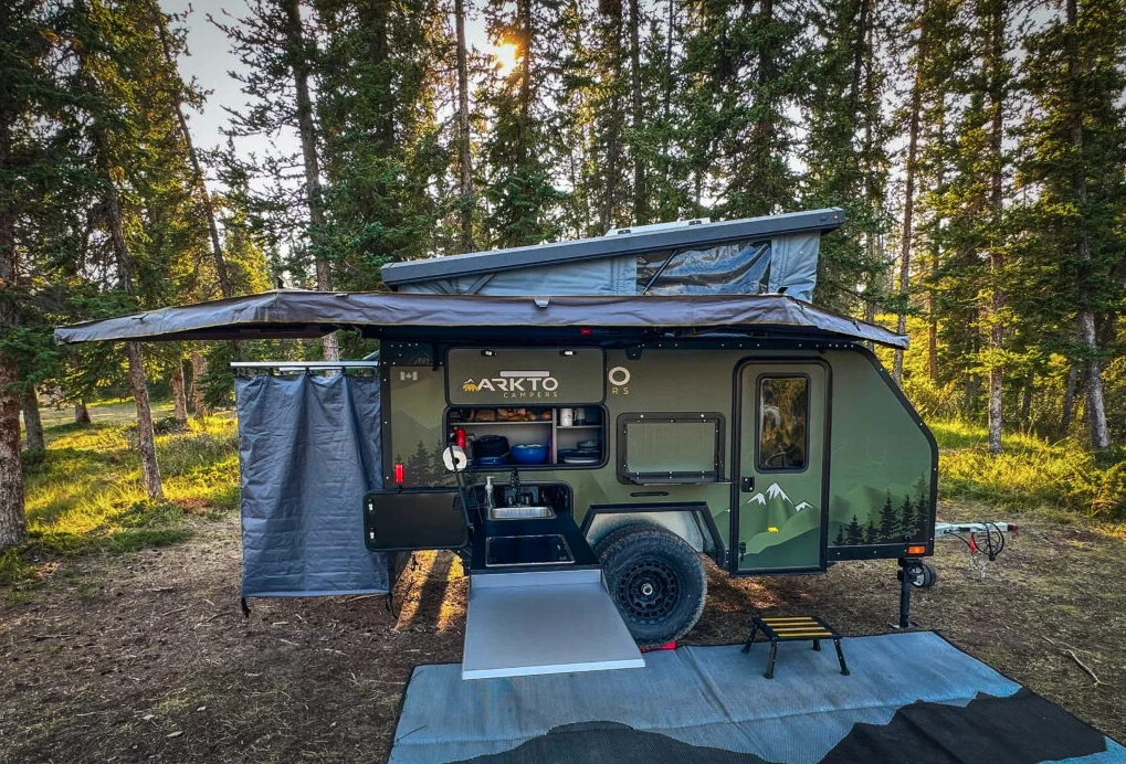 The slide-out galley includes a generously sized worktop that folds over the stove/sink area when closed