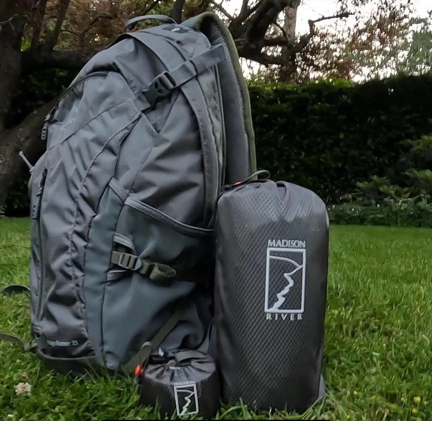 The Atmos and its pump sack (right/center), with a backpack for scale