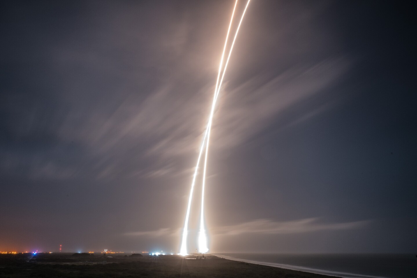 The time-lapsed streaks of a Falcon 9 launch and landing