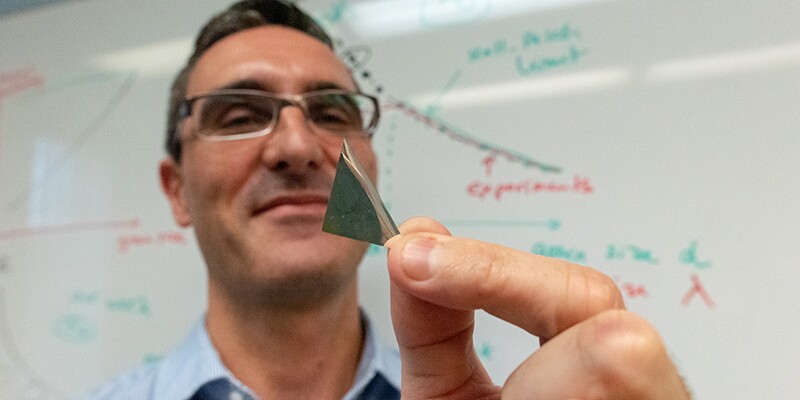 Co-lead author Frederic Sansoz holds a piece of the new silver alloy
