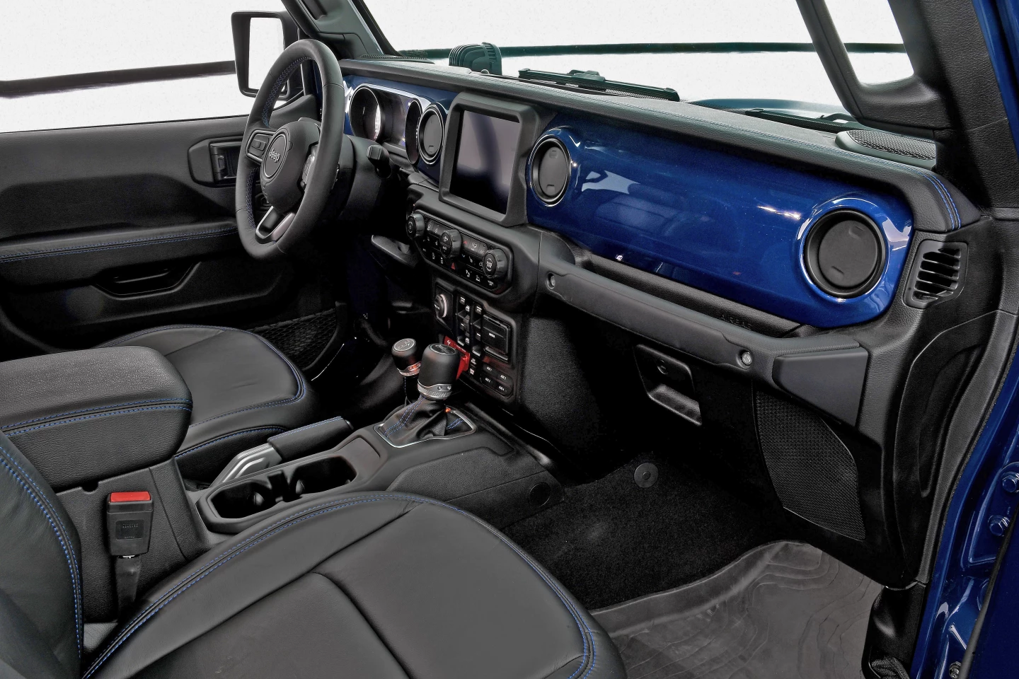 The visual highlight inside is the exterior-matched K9 Blue dashboard facing