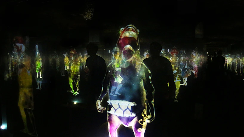 A weird animal hologram looks on (Photo: TeamLab)