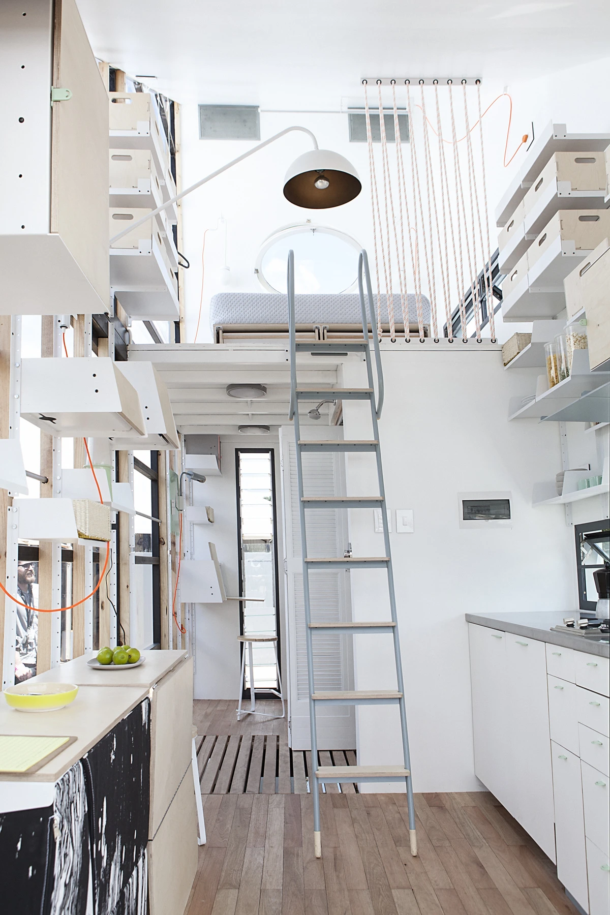 Inside, the POD-Indawo features a wooden floor, bathroom, kitchen area, and a sleeping area that's accessible via ladder (Image: Brett Rubin)