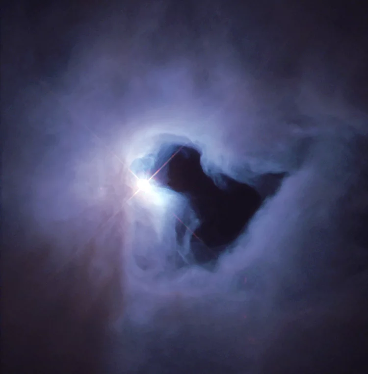NGC 1999 is a reflection nebula, meaning it doesn’t give off its own light but is lit up by a star behind it, like fog around a street light.
