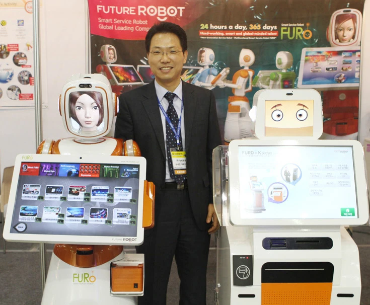 From right: FURO, Future Robot's CEO Se-kyong Song, and FURO-K, a robot kiosk.