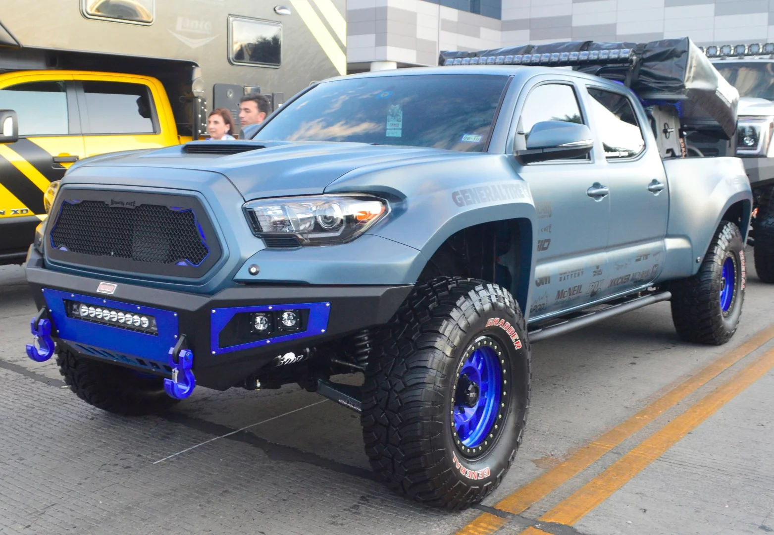 Pickup truck holding a roof-top tent and spare tires