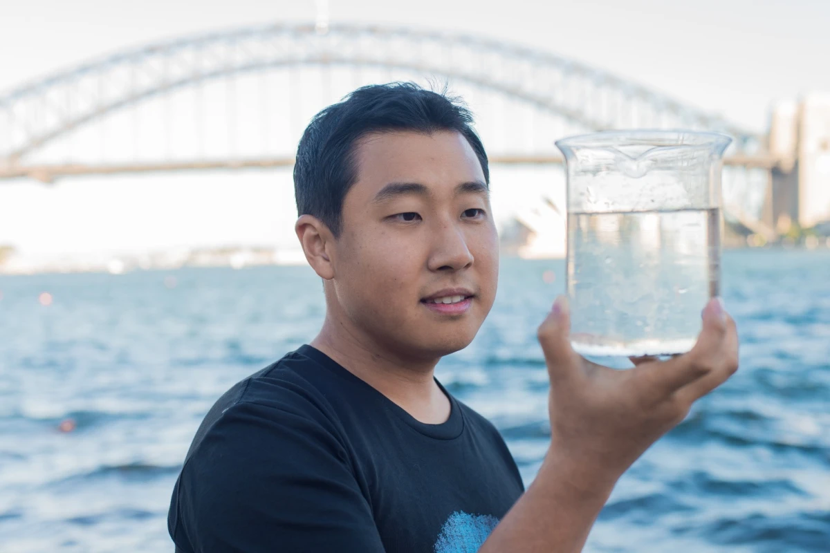 Dong Han Seo, of the CSIRO, holds a flask of water taken from Sydney Harbour, which has been purified to a drinkable standard thanks to a graphene-based filter