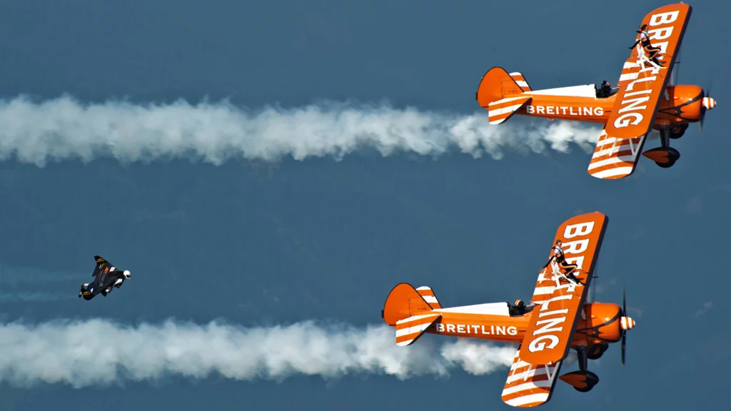 Yves "Jetman" Rossy flies in formation with the Breitling Wingwalkers
