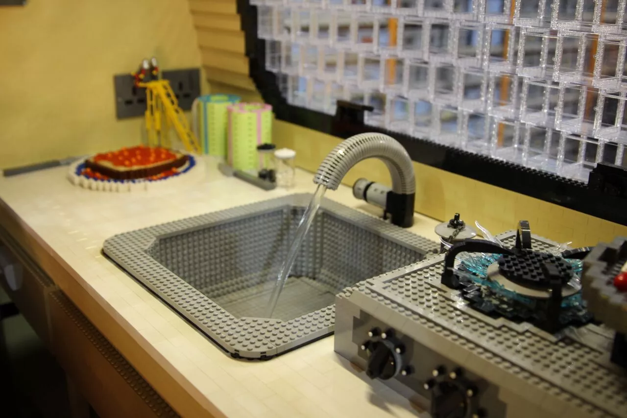 The trailer has real camping amenities, including a sink with running water, working electric lights and a dinette set that transforms into a bed