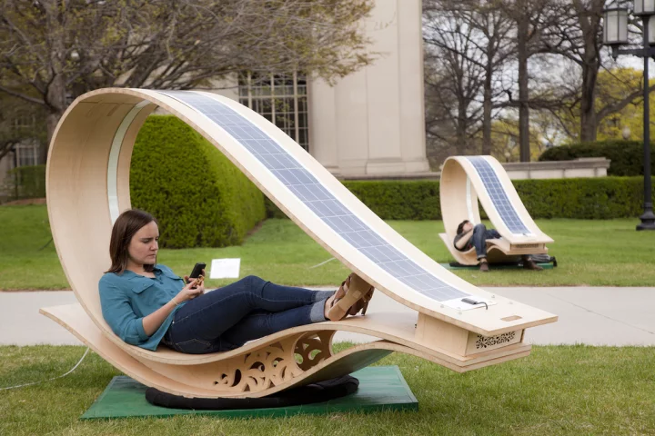 Developed for MIT's Festival of Art Science Technology, the SOFT Rockers use enhanced fabrication techniques to curve flat wooden panels, and have solar panels installed to charge the gadgets of those who relax within (All images courtesy of Phil Seaton)