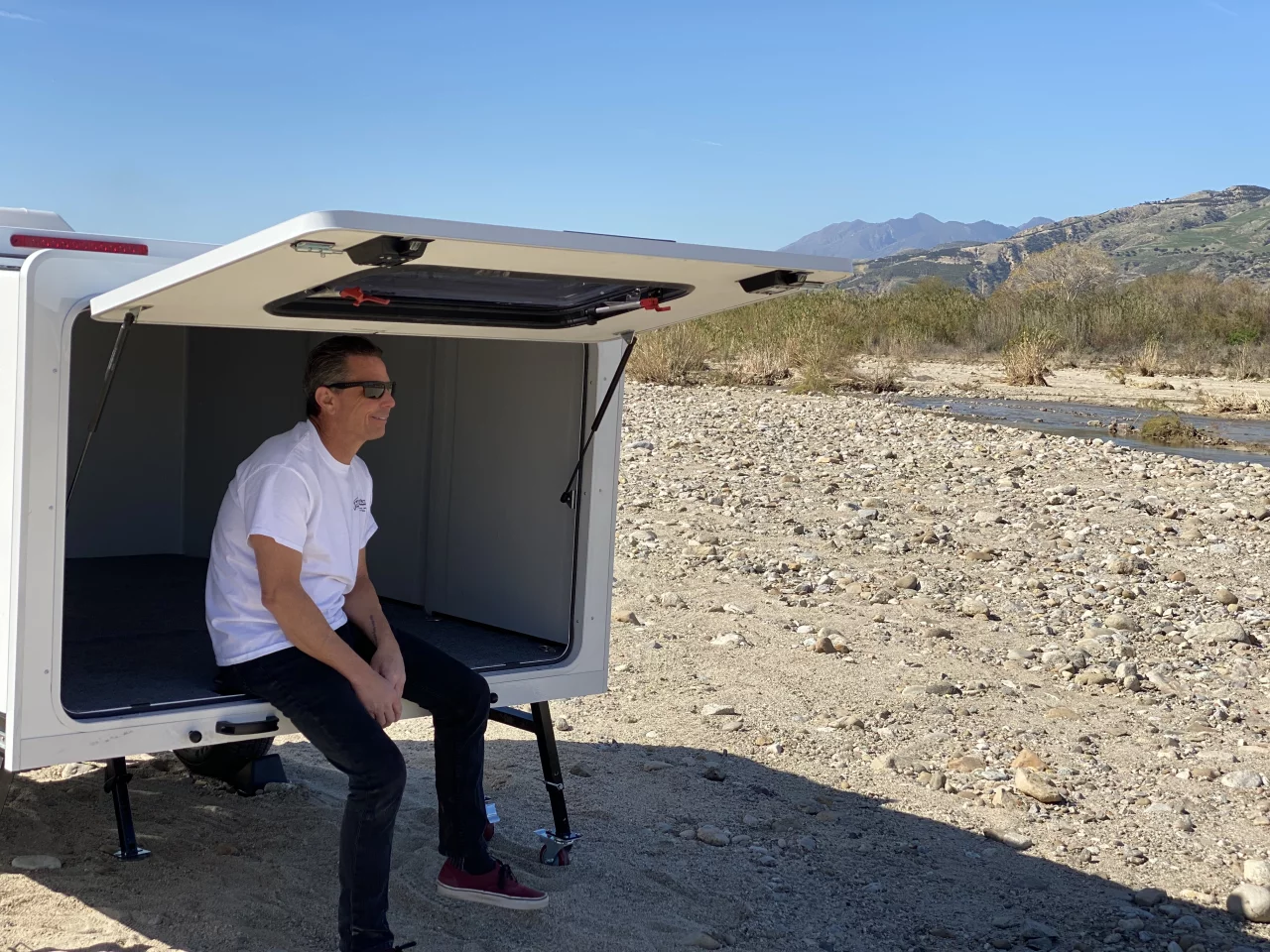 The Hitch Hotel is really more like a hard-sided tent than a full camping trailer, offering a sheltered space for two+ adults and a window and fan