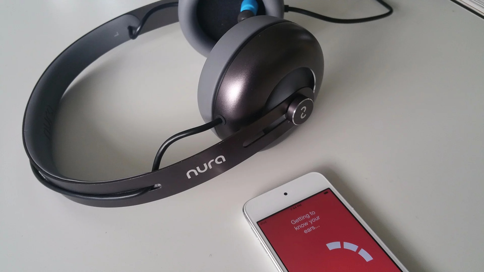 Nura headphones: the earbud probe is visible in the top headphone