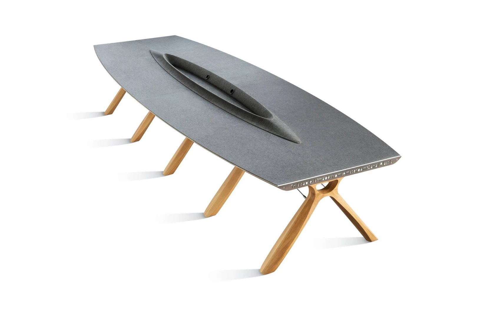 The design of Plastic Whale's 4 meter long boardroom table was inspired by a surfacing whale