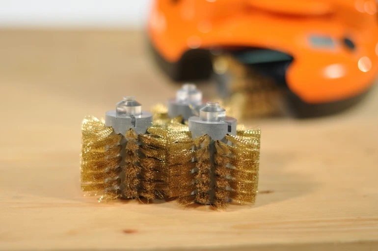 Grillbot is a robot powered by three electric motors that uses three replaceable brushes to scrub clean your grilling surface