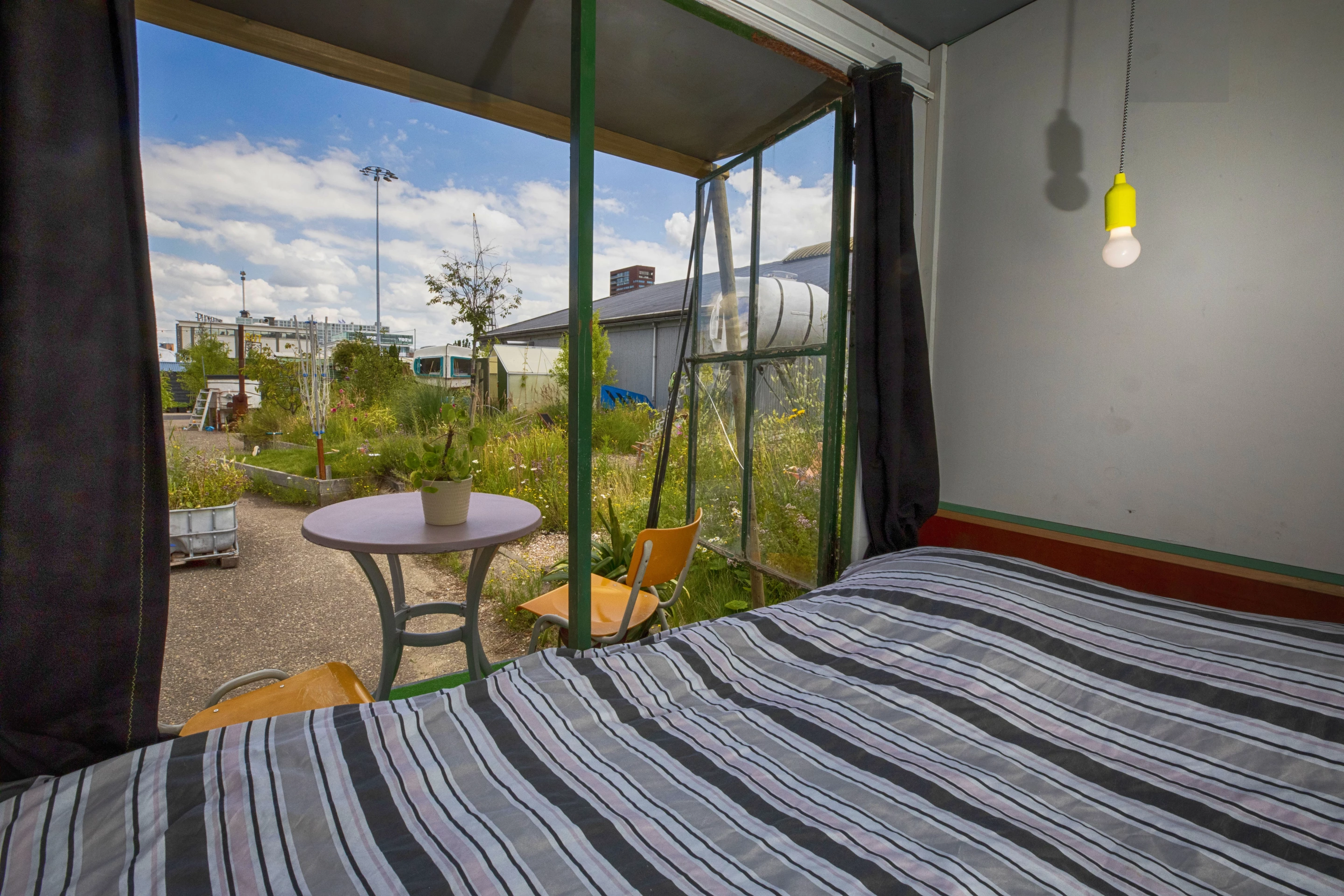 Sweet Potato sleeps two with a double bed and also features a small patio area with a table and chairs