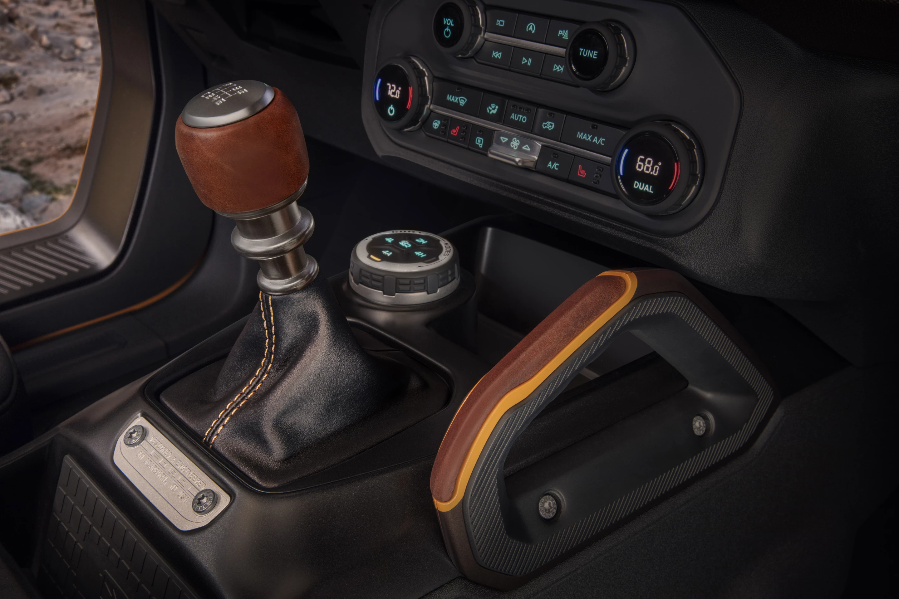 Customization details include an available leather-wrapped shift lever for the 7-speed manual transmission and grab handles