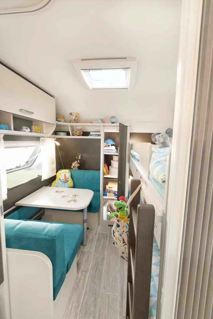 The front of the C'Go Up houses a kids' area with bunk beds, dedicated dinette set and storage shelving