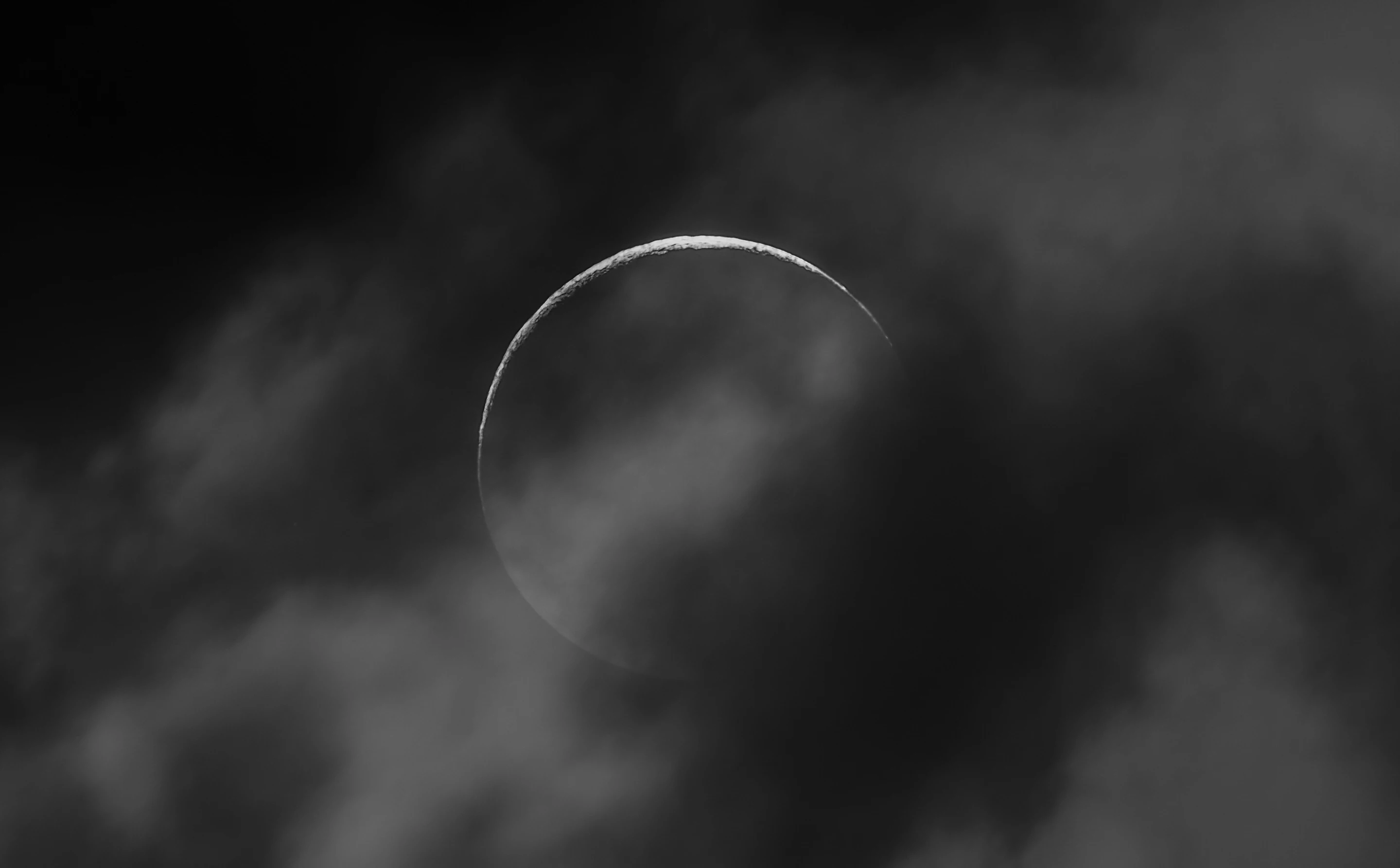 Our Moon Highly Commended: Crescent © Jinyuan Chen (China). A beautiful crescent Moon almost appears like an eclipse behind the clouds