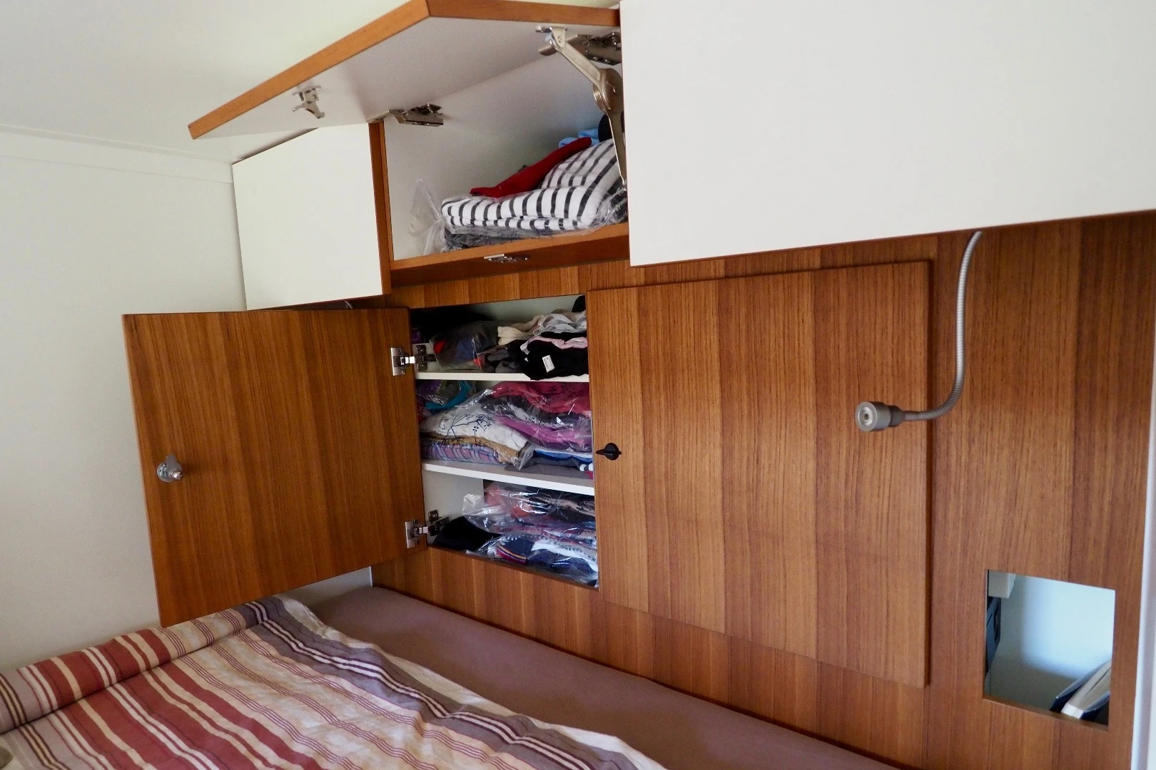 Clothes and accessory storage over the bed