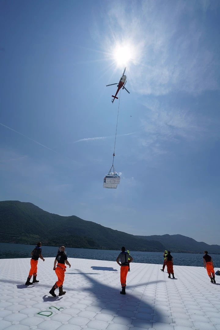Felt that will cover the cubes underneath the yellow fabric is transported from Montecolino to San Paolo island by Elimast Helicopter Service