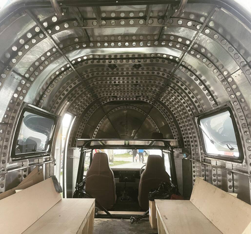 We look forward to seeing the finished interior, but there's something rather spectacular about the bare aluminum walls and Erector-like frame members