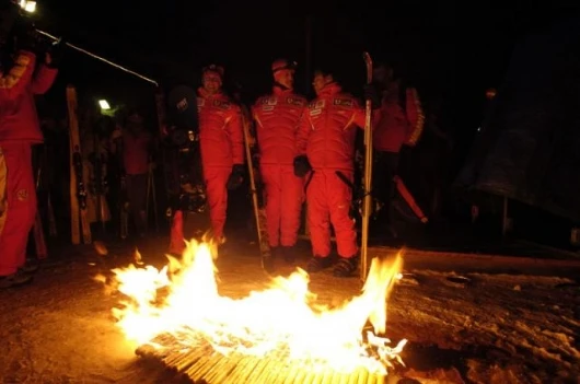 Ferrari F1 drivers around the camp fire