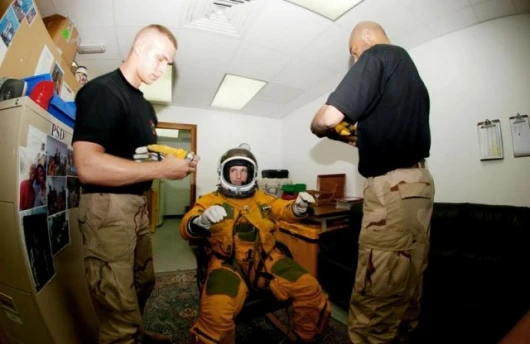 Senior Airman Duane Thompson (left) and Staff Sgt. Shann Elmore help Maj. Cory Bartholomew into his space suit before a flight in a U-2 reconnaissance aircraft. Airman Thompson and Sergeant Elmore are life-support crewmembers with the 99th Expeditionary