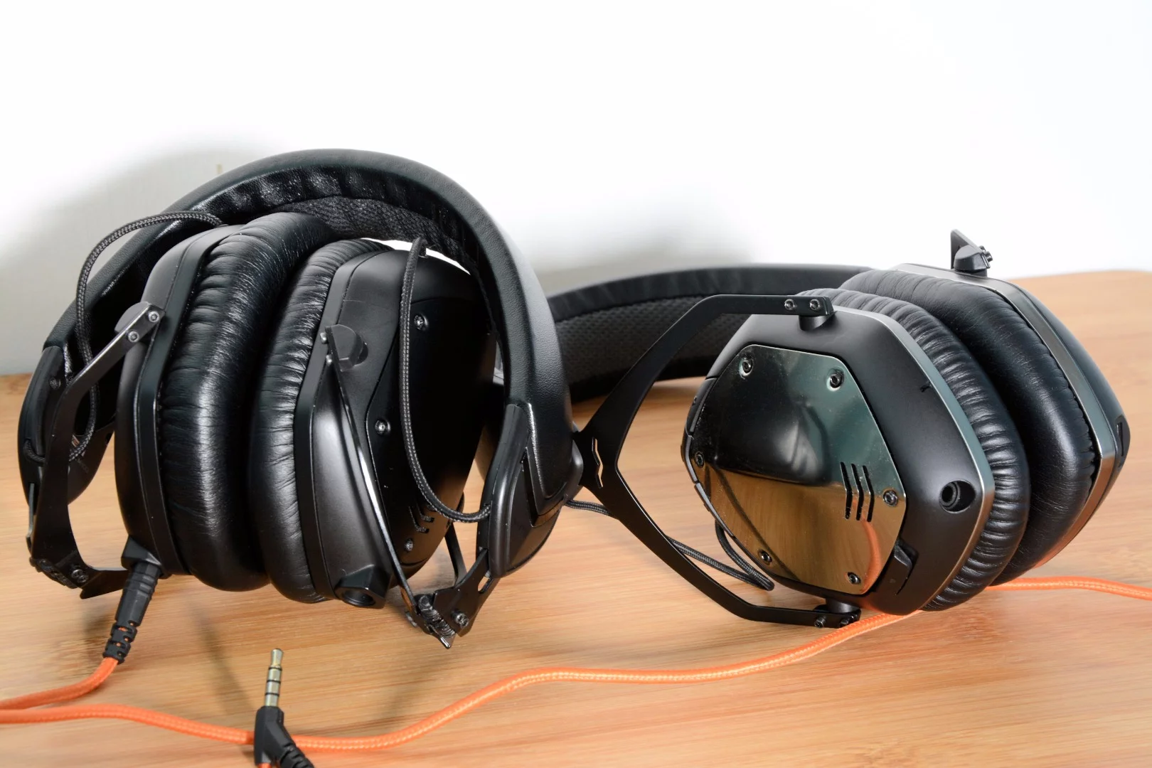 The most obvious design difference between the M-100s (left) and the Wireless headphones (right) is the lack of a CliqFold hinge in the latter