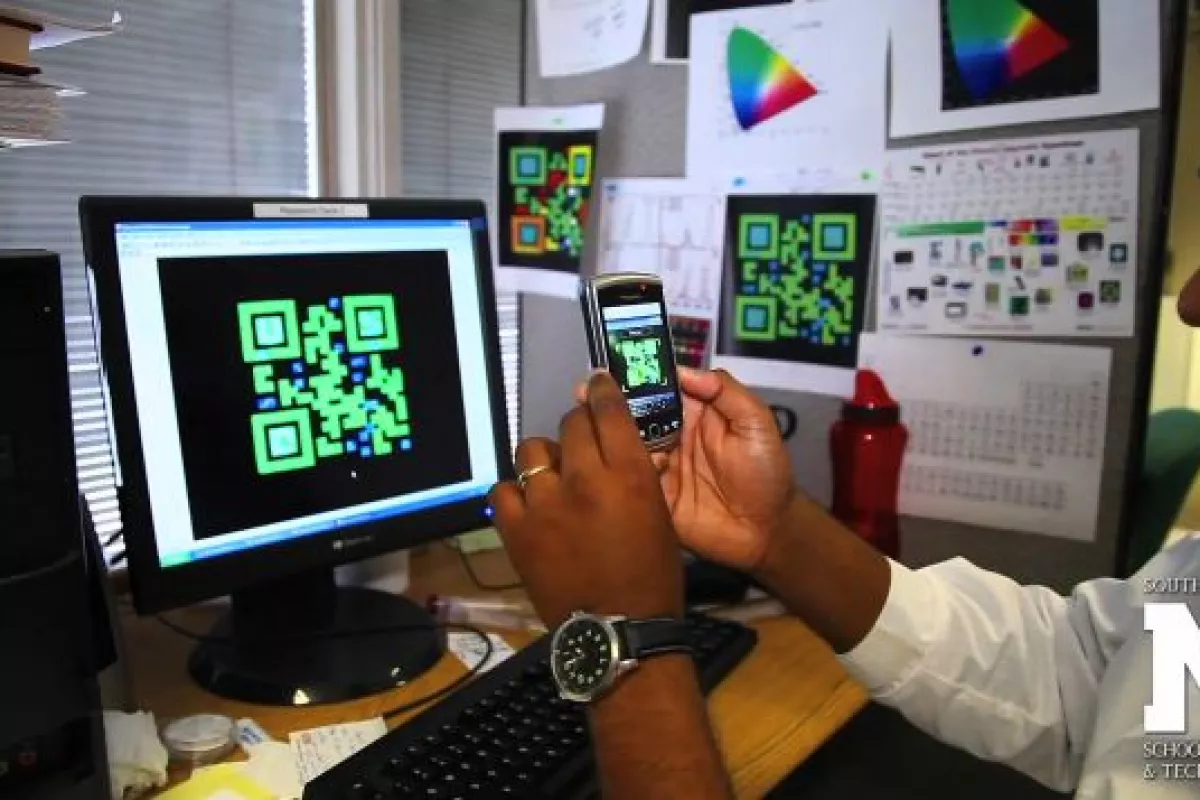 An AutoCAD rendering of one of the QR codes, being read by a smartphone