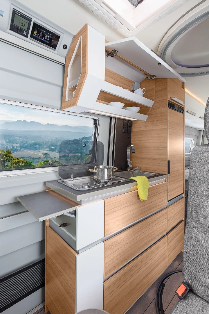 The kitchen area is fairly basic, featuring a dual-flame stove, sink, countertop extension and storage. The built-in LED strips below the countertop are a nice-looking touch