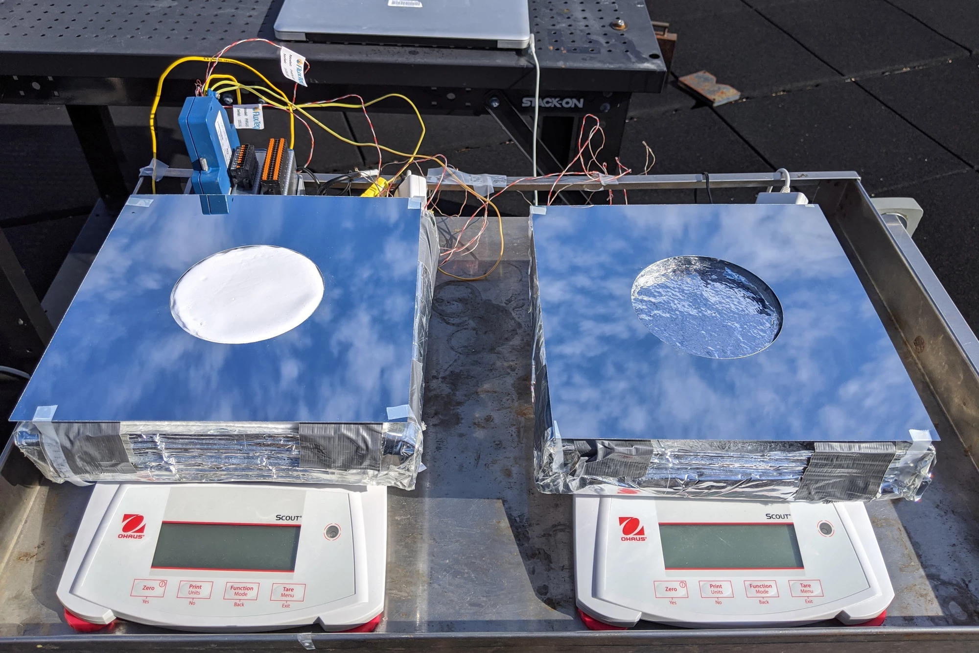 A 4-inch (102-mm) square version of the device (left) is tested on an MIT rooftop – at right is a device utilizing only evaporative cooling, for comparative testing