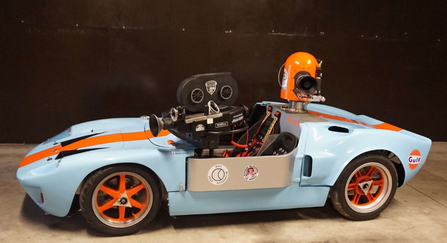 When Steve McQueen's Solar Productions was filming the 1971 film Le Mans, one of the camera cars was a Ford GT 40 in Gulf colors which was transformed into a "barchetta" and equipped with cameras. The car subsequently was transformed back into a complete GT40 and became the most expensive movie car ever to sell at auction (fetching US$11,000,000 at an RM Auctions sale at Pebble Beach in 2012) with a prominent spot in the top 100 most expensive cars of all time. This is a tribute 2/3 scale junior car with real movie cameras and it fetched $39,821 (€32,500) ... truth is stranger than fiction.