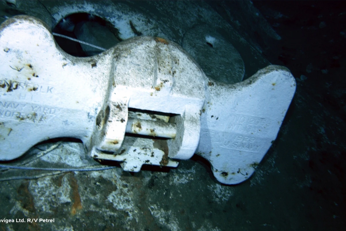 An image shot from a remotely operated vehicle shows the bottom of an anchor clearly marked "US Navy"