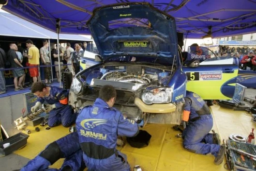 Parc ferme and the Subaru crew work on Solberg's machine