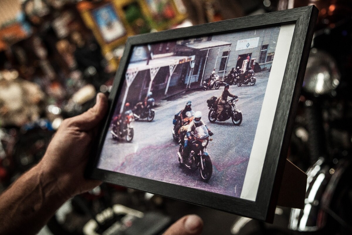 John Gee holds up a photo of his Honda Four - as pictured in the iconic first Mad Max movie.