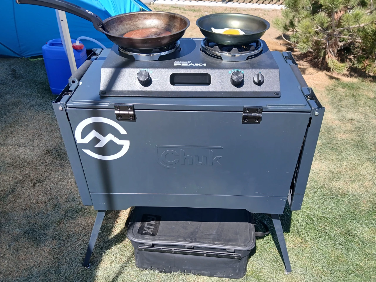 We stumbled upon the Chuk box at an unrelated booth at Overland Expo Mountain West, where it was closed with a stove on top and Rux cargo box peeking out from below