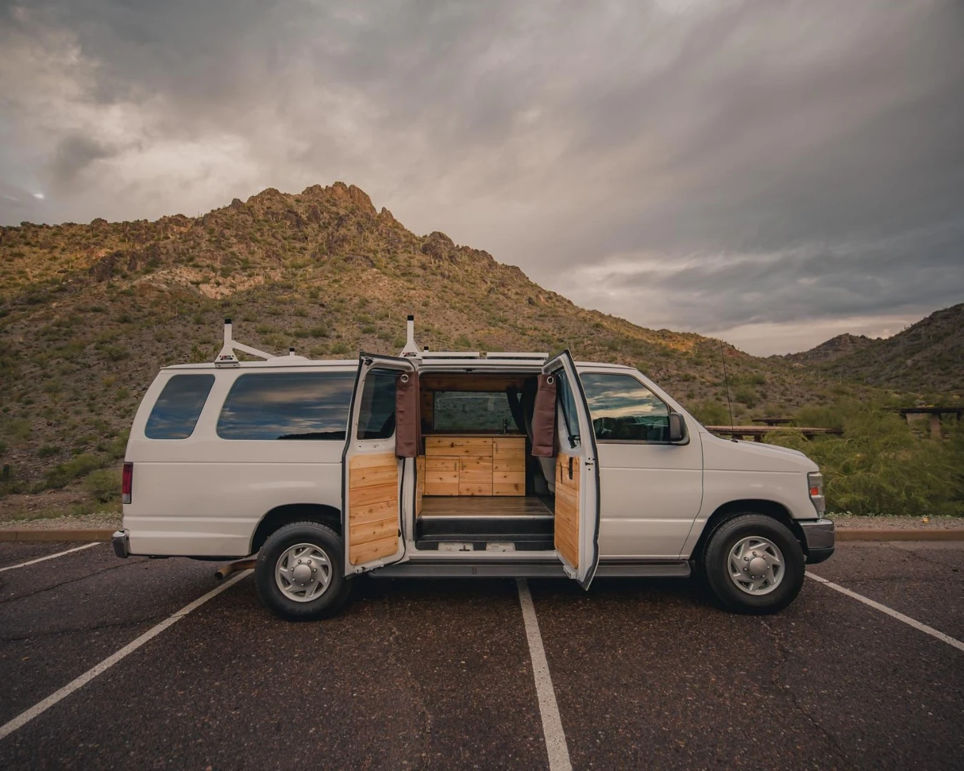 A big, old extended Ford E-350 Boho camper van known as Rev-Van