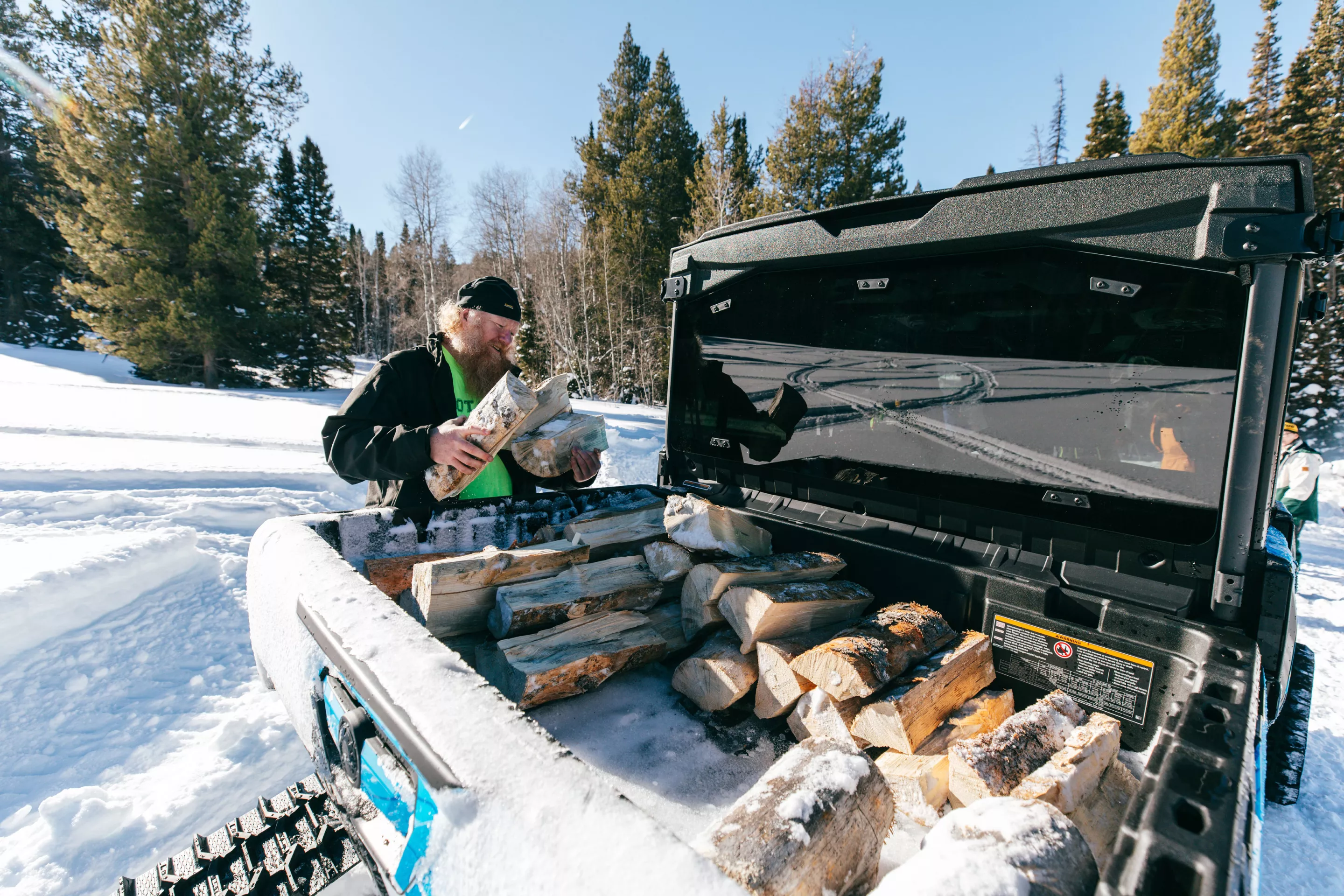 A man, his beard, and some chopped wood. All we need besides the Can-Am to haul the wood is some generic country rock music to overlay the scene