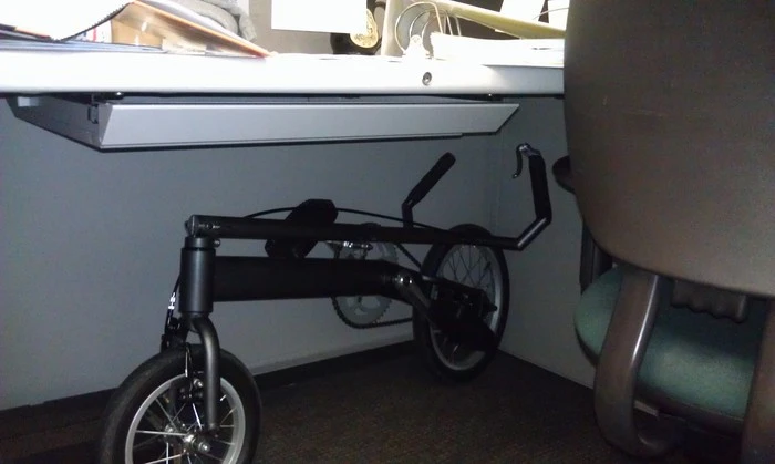 The Occam Cycle folded down and stored under a desk